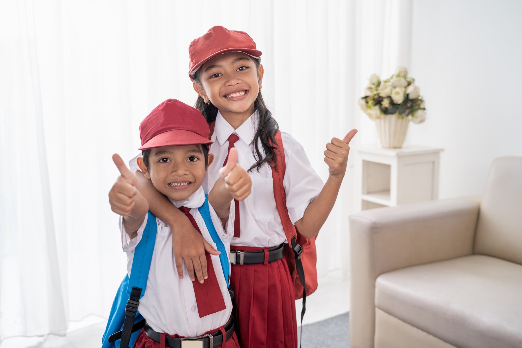 Primary Student Wearing School Uniform Showing Thumbs up